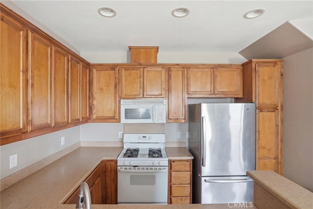 131 Watering Place Templeton, CA 93465 - Photo 12 of 27 a kitchen with a refrigerator a stove a sink and a window