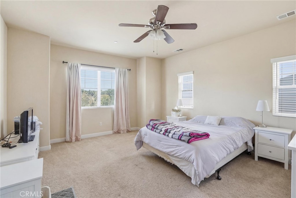 131 Watering Place Templeton, CA 93465 - Photo 15 of 27 a bedroom with a bed a chandelier and a window
