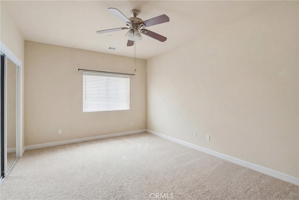 131 Watering Place Templeton, CA 93465 - Photo 23 of 27 an empty room with a chandelier fan and windows