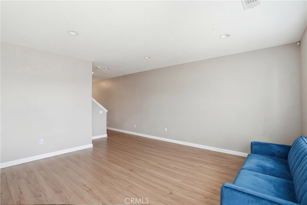131 Watering Place Templeton, CA 93465 - Photo 5 of 27 a view of an empty room with wooden floor and a rug