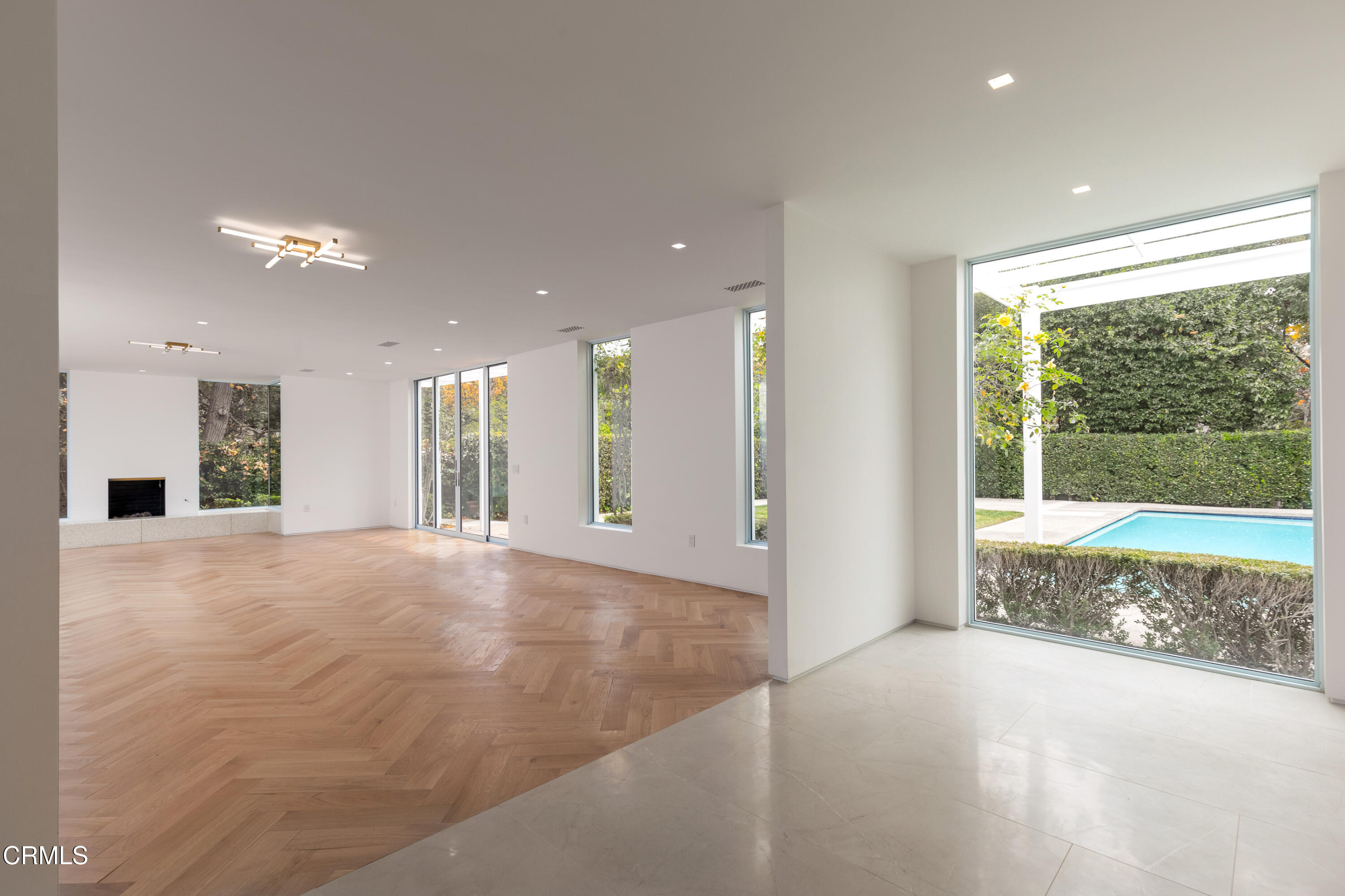 800 Canon Drive Pasadena, CA 91106 - Photo 12 of 49 a view of an empty room with a fireplace and a window
