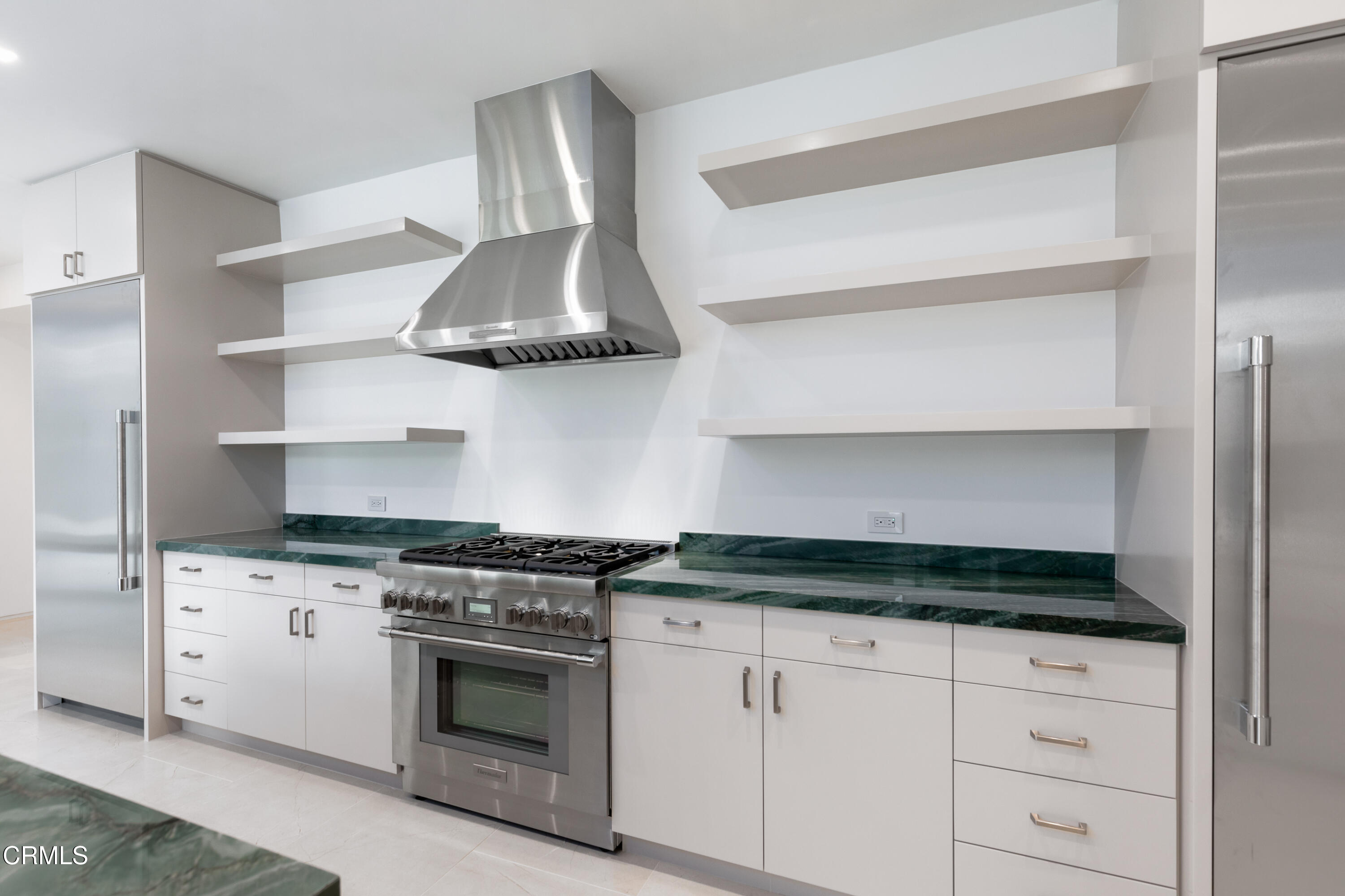 800 Canon Drive Pasadena, CA 91106 - Photo 21 of 49 a kitchen with stainless steel appliances granite countertop white cabinets and a stove