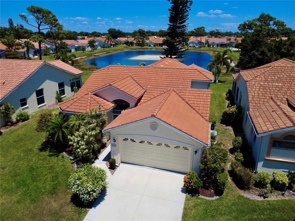 4266 Summertree Road Venice, FL 34293 - Photo 40 of 64 an aerial view of multiple houses with a yard
