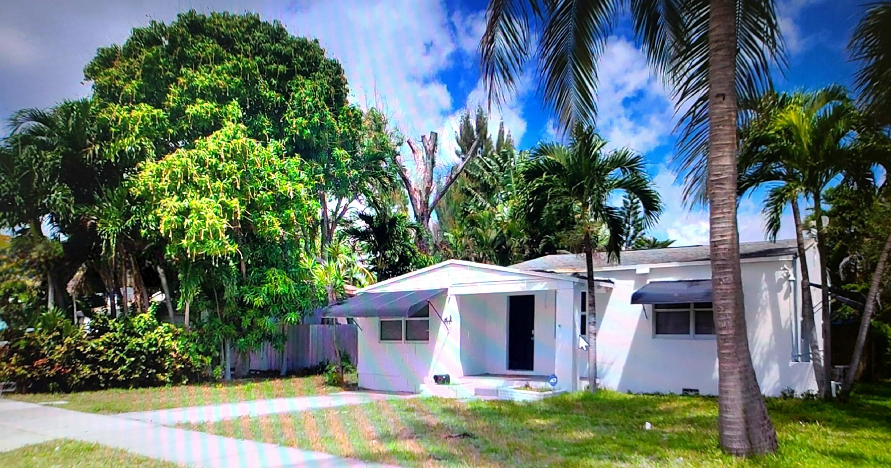 1821 Harding Street, Unit 12 Hollywood, FL 33020 - Photo 1 of 14 a front view of a house with a garden