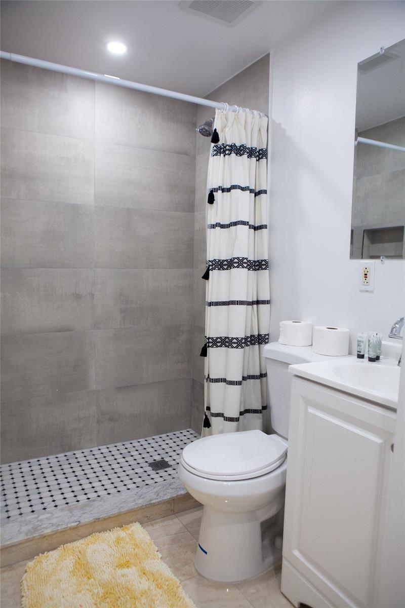 1821 Harding Street, Unit 12 Hollywood, FL 33020 - Photo 12 of 14 a bathroom with a toilet a sink and shower