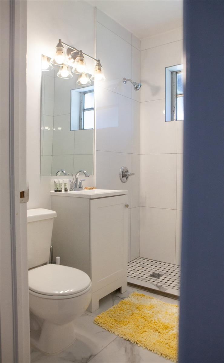 1821 Harding Street, Unit 12 Hollywood, FL 33020 - Photo 14 of 14 a bathroom with a sink a toilet and shower