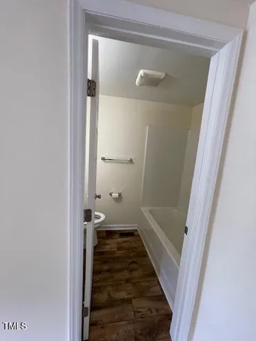a bathroom with a glass door shower and a sink