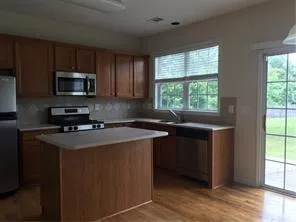 a kitchen with stainless steel appliances granite countertop a stove a microwave a sink and a refrigerator