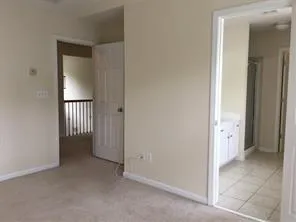 an empty room with a bathroom and a sink