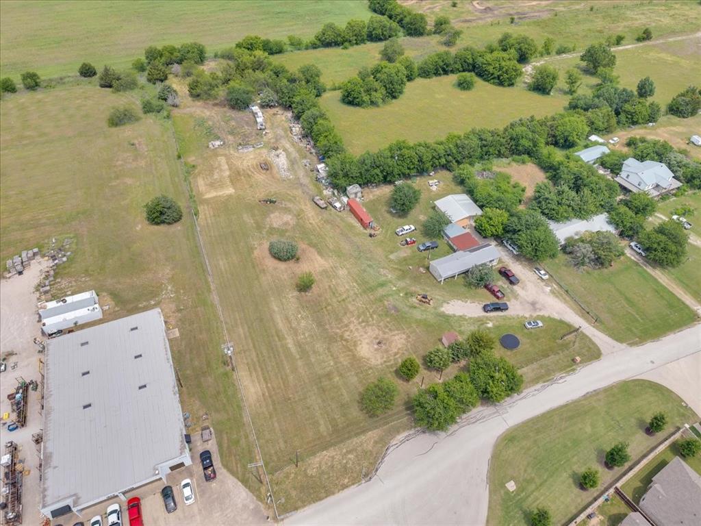 2511 Mathis Road Mansfield, TX 76063 - Photo 17 of 23 Property featuring a large commercial building with a gray roof and ample parking