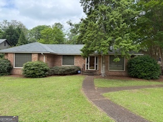 103 Ivydale Drive LaGrange, GA 30240 - Photo 1 of 1 a front view of a house with a garden and trees