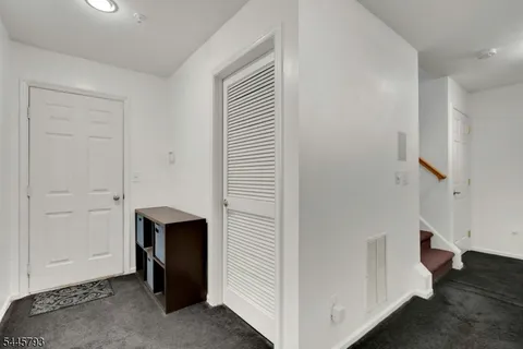 an entryway with a white walls