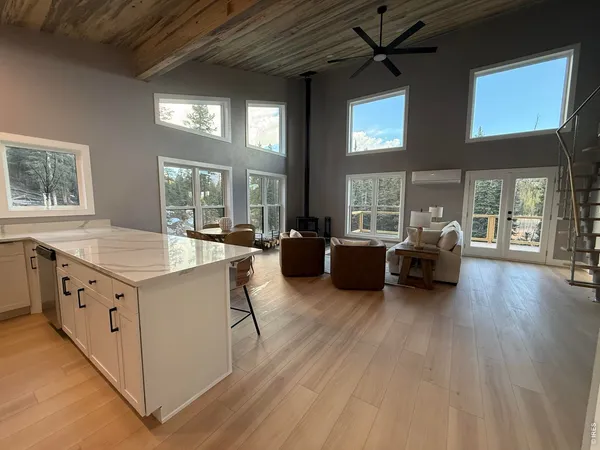 a kitchen with stainless steel appliances kitchen island granite countertop a refrigerator a stove top oven a sink and dishwasher