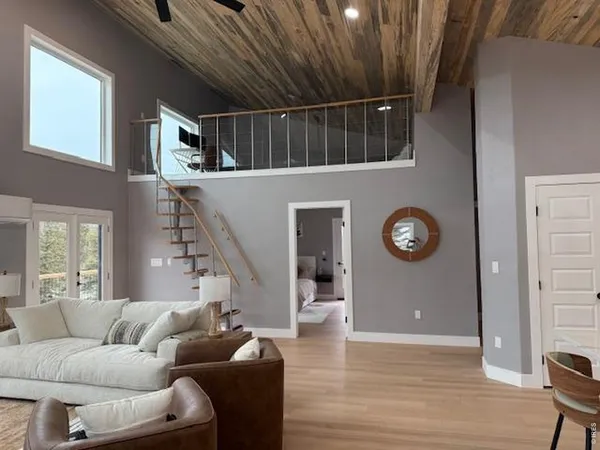 a living room with furniture and a chandelier