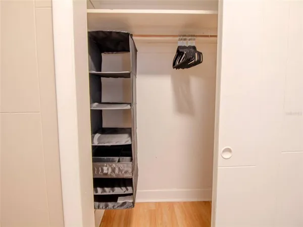 a close view of walk in closet with clothes