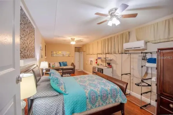 a bedroom with furniture and a large window