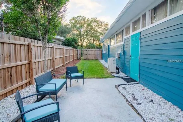 a view of a chair and table in backyard