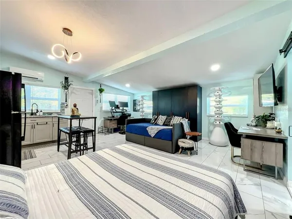 a bedroom with furniture and a large window