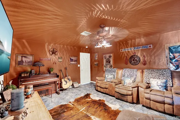 a living room with furniture and a chandelier