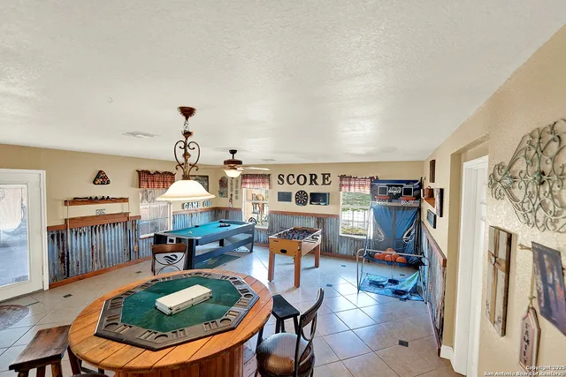 a living room with furniture a rug and a painting on the wall