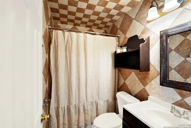 a bathroom with a toilet sink and tub