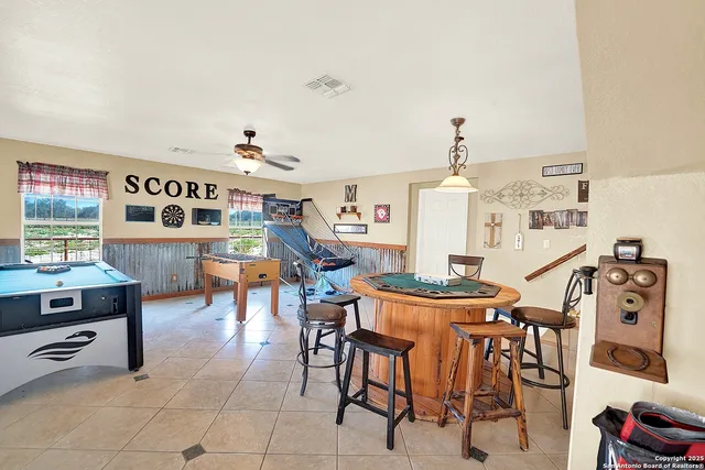 a view of a dining room with furniture and a chandelier