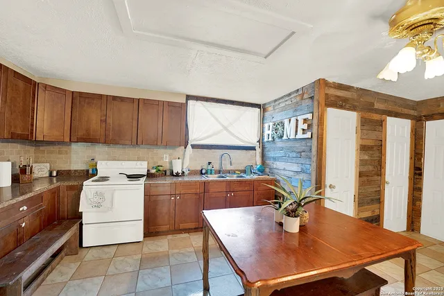 a kitchen with a stove a refrigerator and wooden cabinets