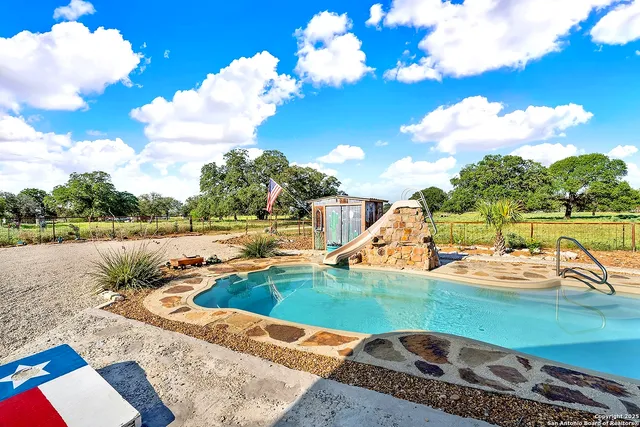 a view of a swimming pool with a lounge chairs