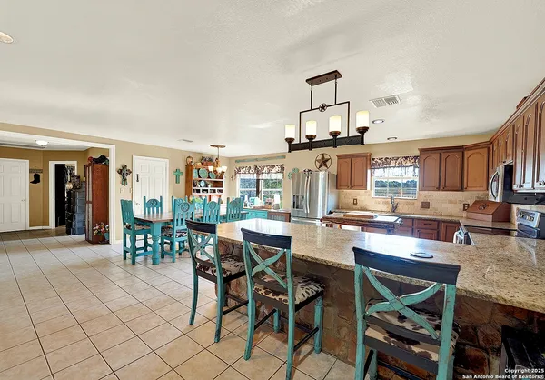 a room with furniture a dining table and chairs