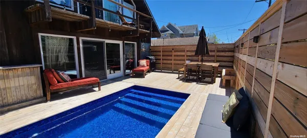 a view of sitting area with furniture and wooden deck
