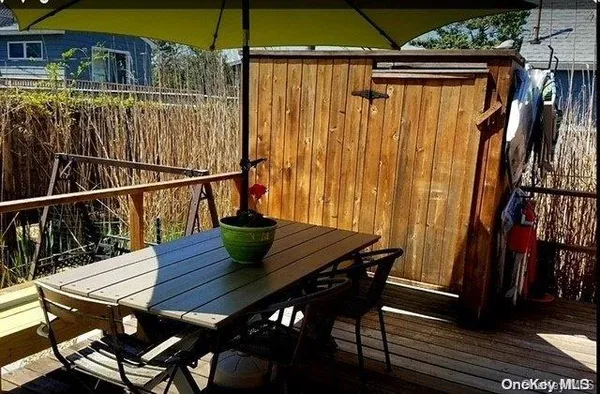 a view of balcony with wooden floor and outdoor seating