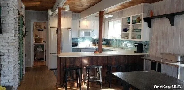 a kitchen with a table chairs refrigerator and cabinets