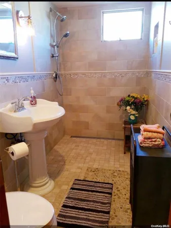 a bathroom with a sink toilet and shower