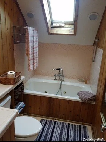 a bathroom with a sink a toilet and bathtub