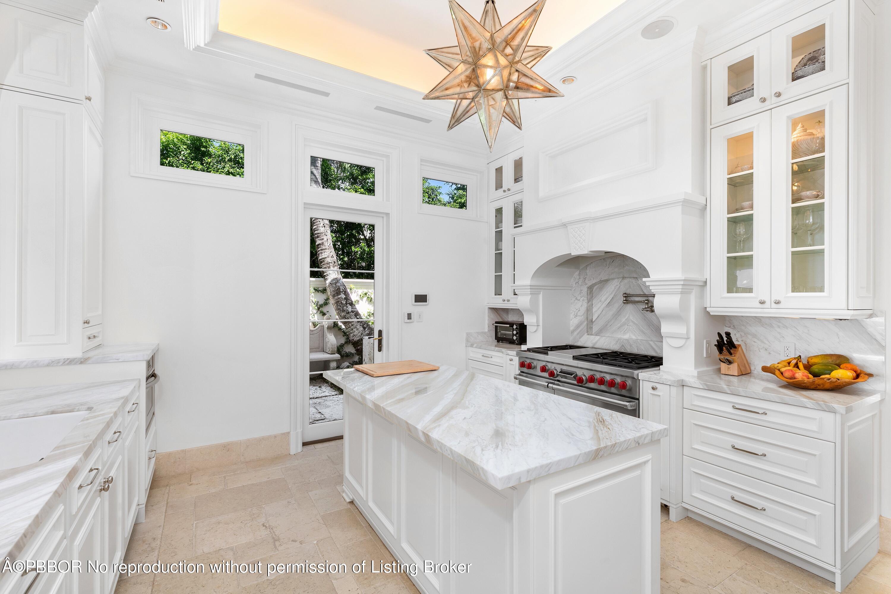 313 Dunbar Road Palm Beach, FL 33480 - Photo 17 of 73 a kitchen that has a lot of cabinets in it