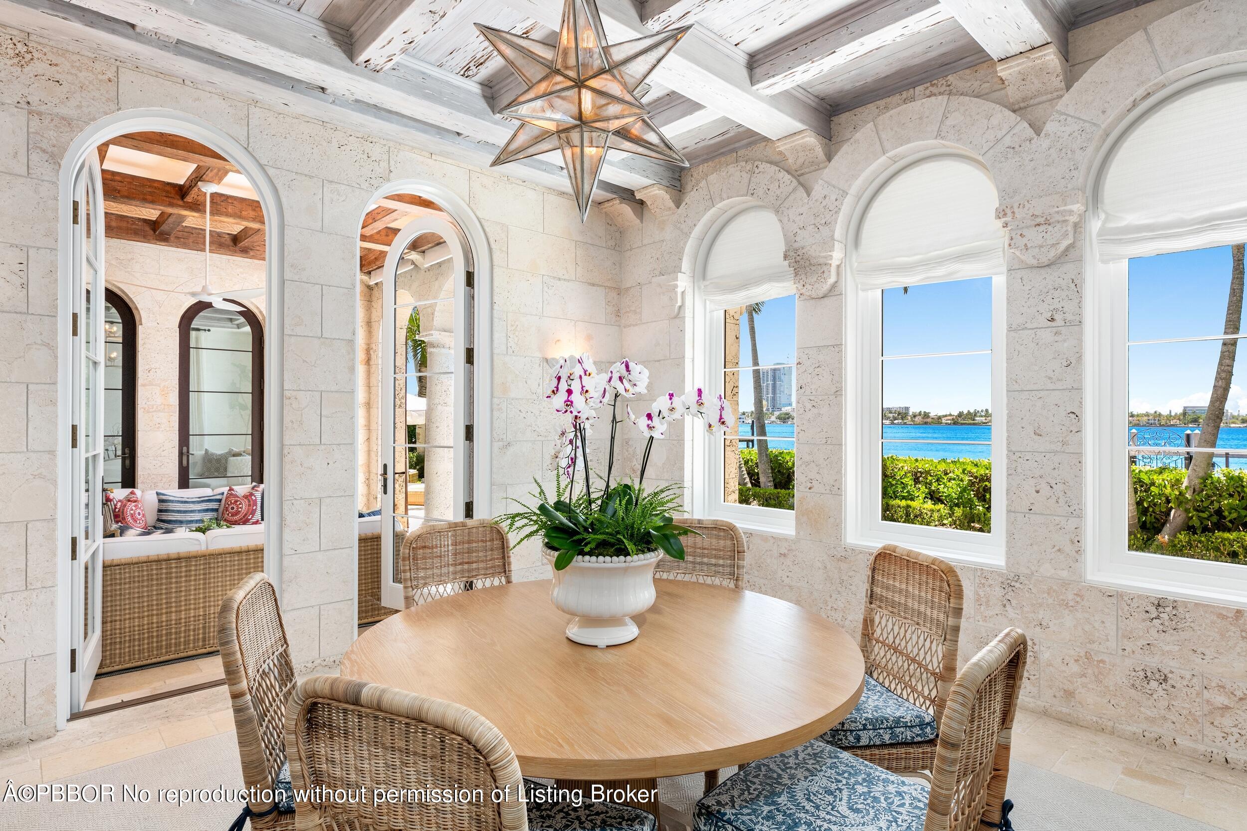 313 Dunbar Road Palm Beach, FL 33480 - Photo 20 of 73 a view of a dining room with furniture and a potted plant