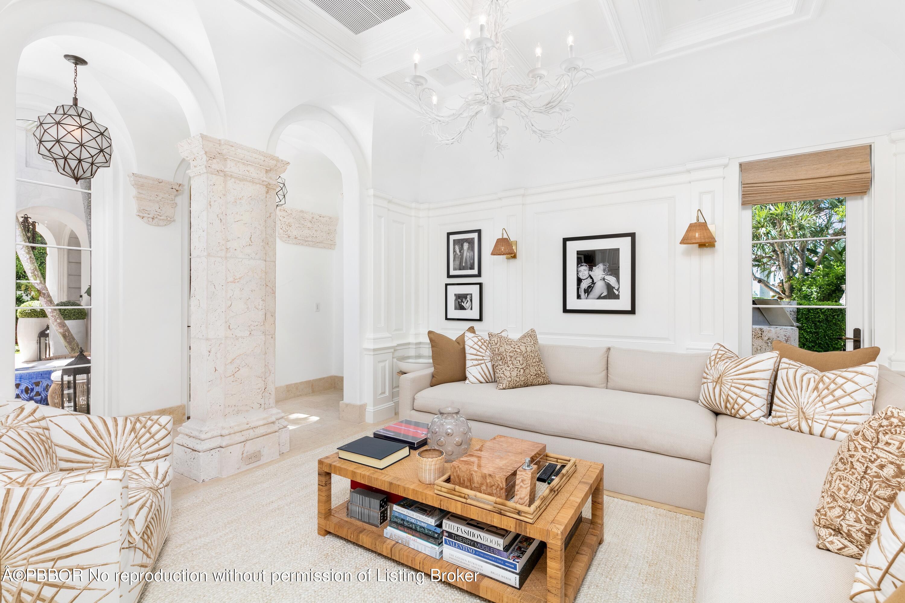 313 Dunbar Road Palm Beach, FL 33480 - Photo 24 of 73 a living room with furniture a chandelier and a table