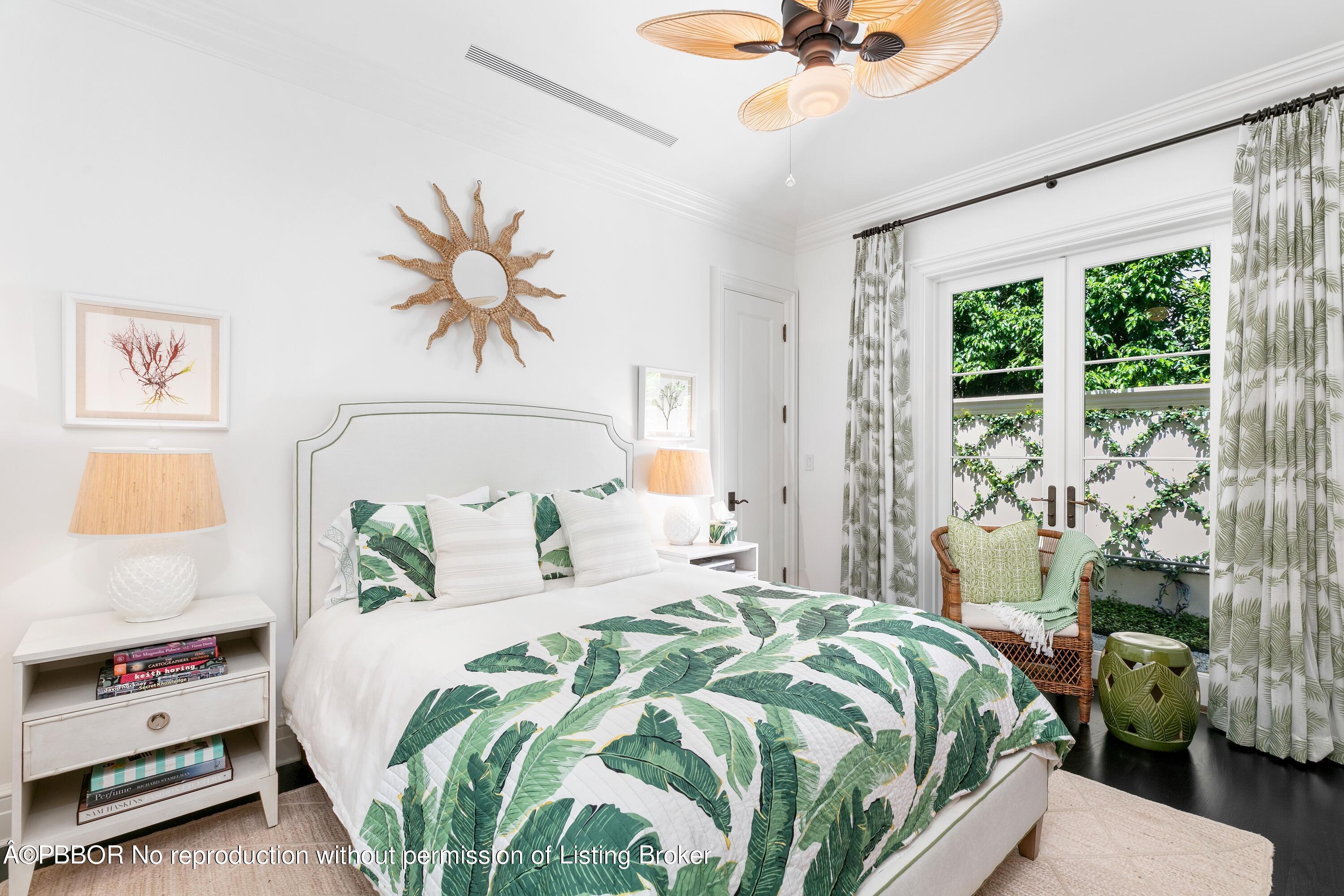 313 Dunbar Road Palm Beach, FL 33480 - Photo 37 of 73 a bedroom with a bed and a chandelier
