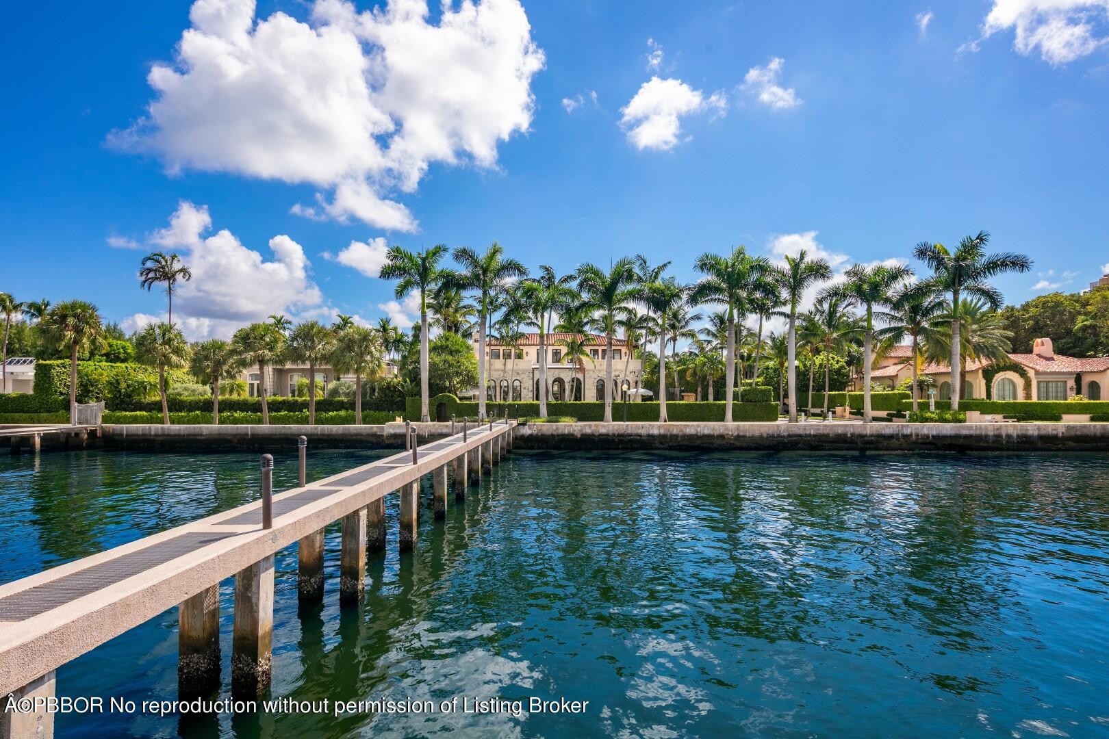 313 Dunbar Road Palm Beach, FL 33480 - Photo 4 of 73 a view of a lake with a house in the background