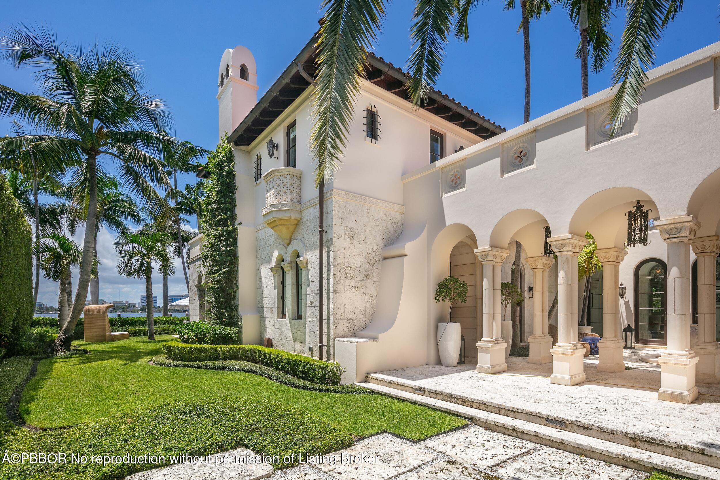 313 Dunbar Road Palm Beach, FL 33480 - Photo 42 of 73 a front view of a house with garden