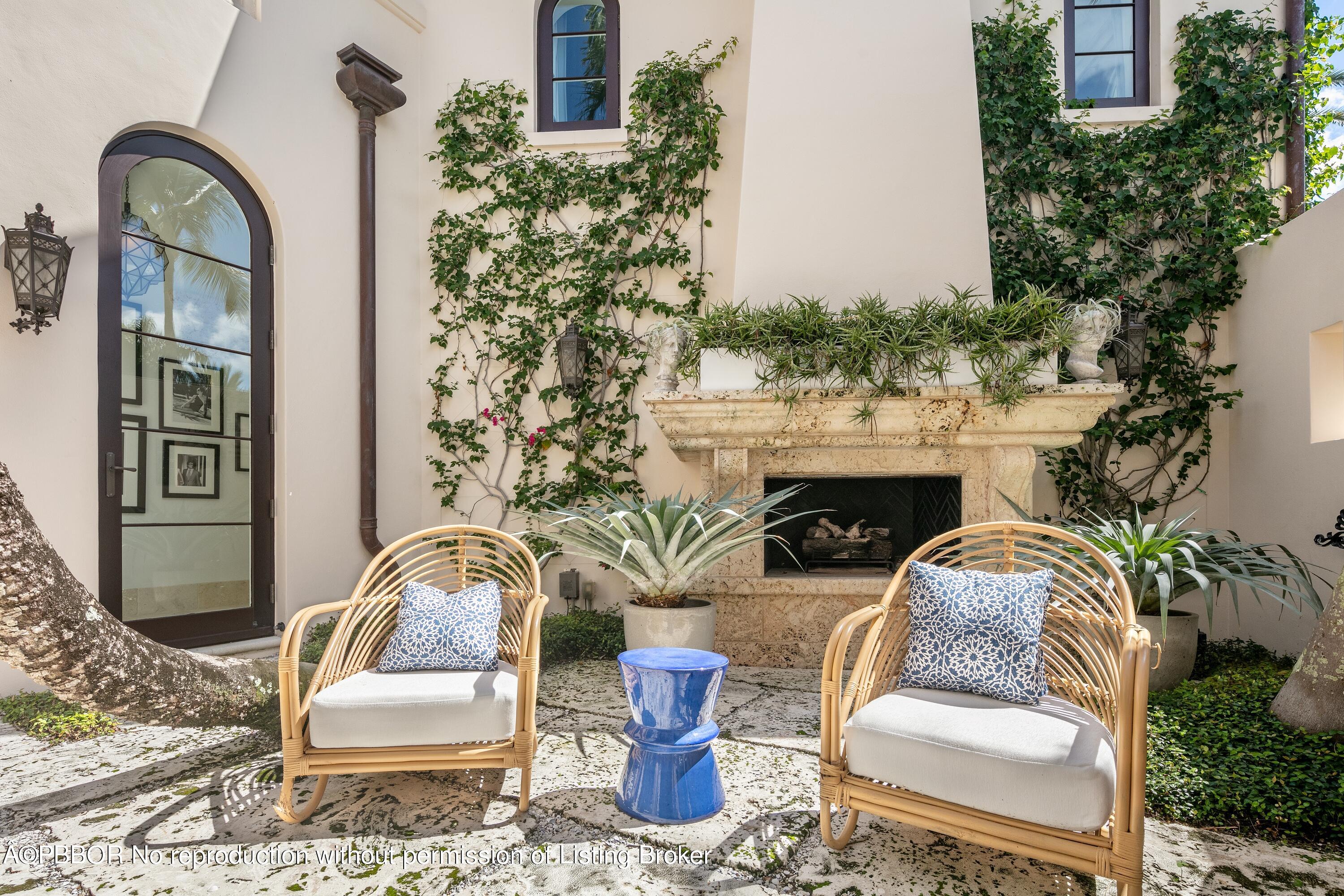 313 Dunbar Road Palm Beach, FL 33480 - Photo 46 of 73 a front view of a house with outdoor seating and plants
