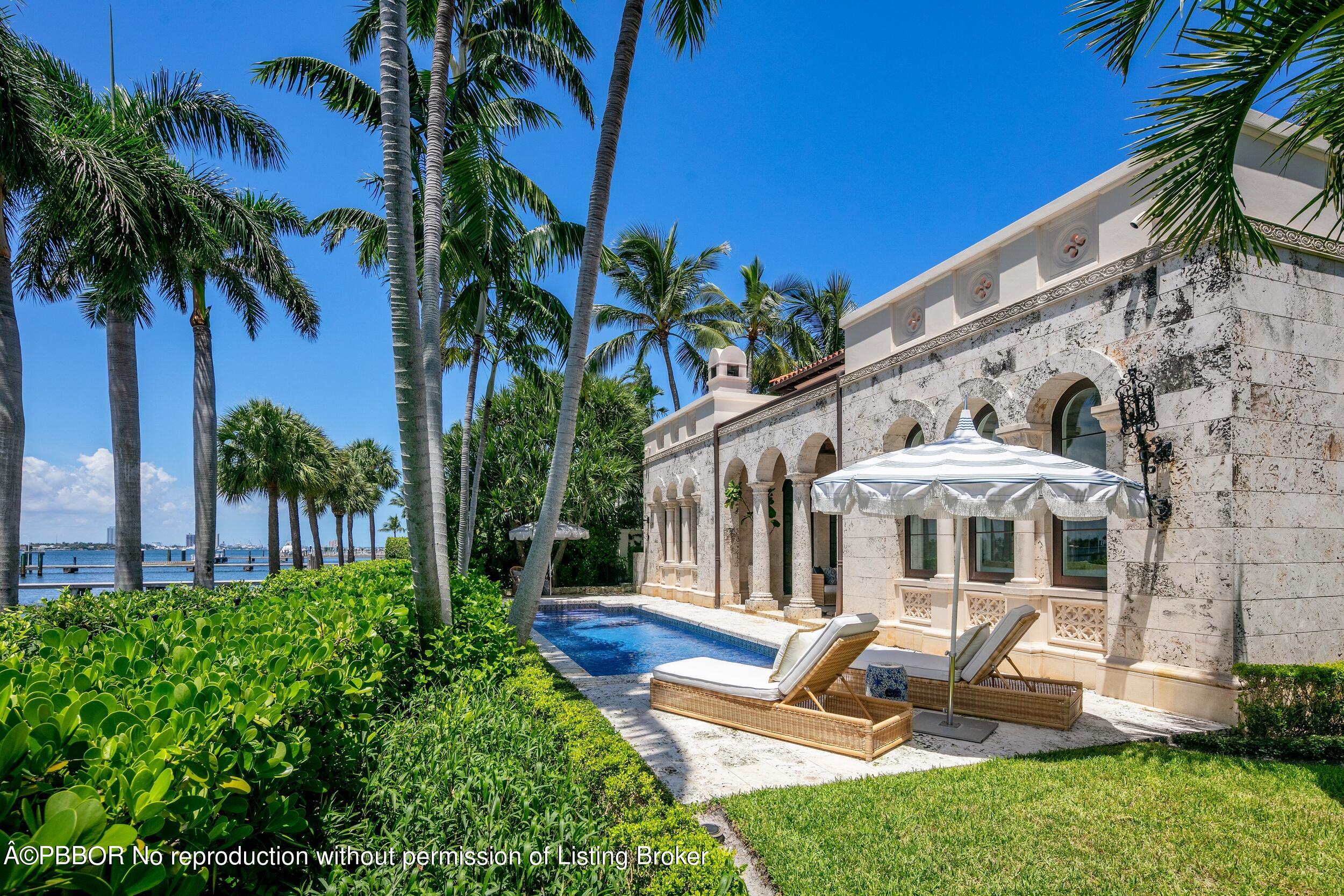 313 Dunbar Road Palm Beach, FL 33480 - Photo 52 of 73 a front view of a house with garden