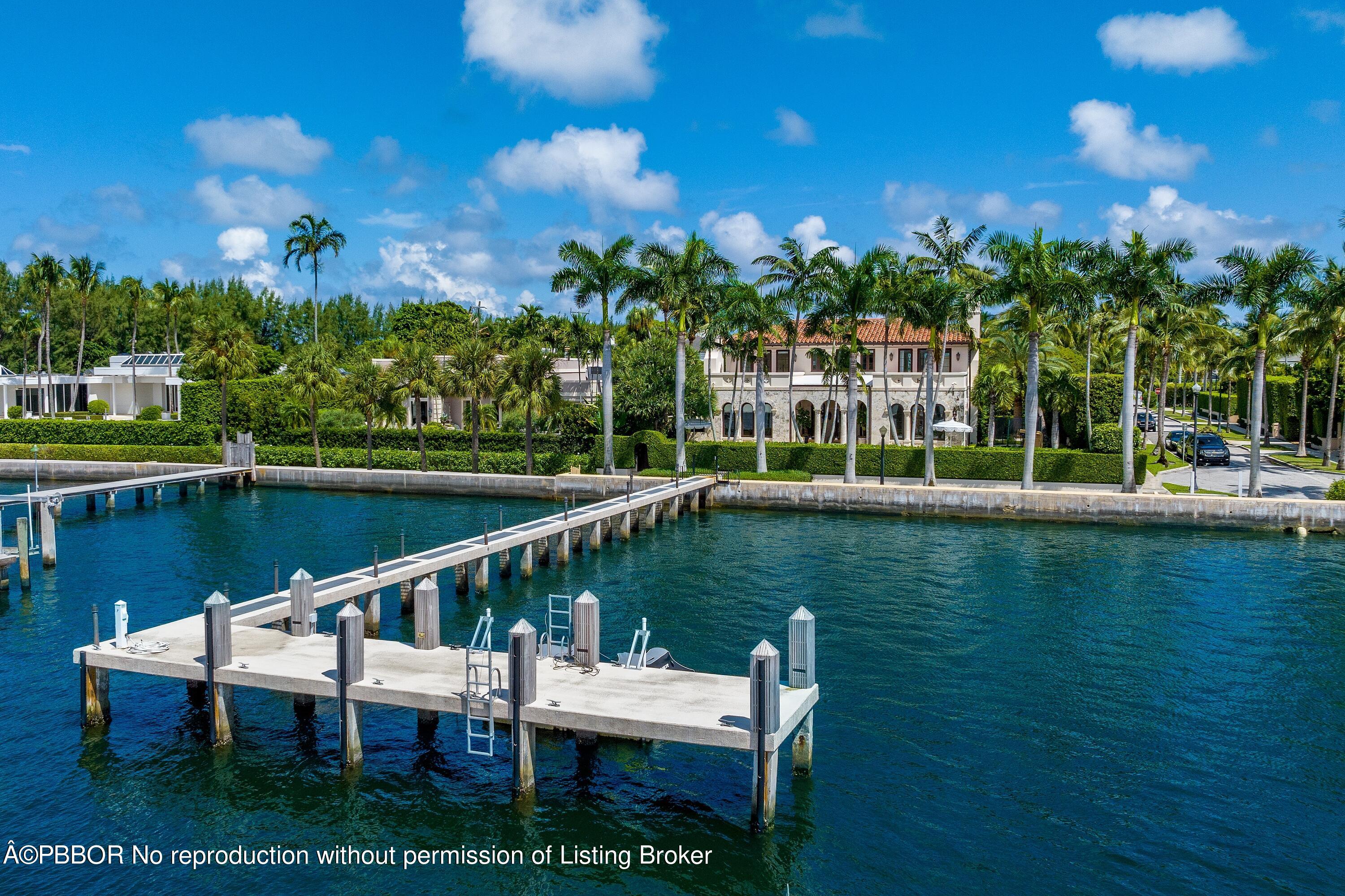 313 Dunbar Road Palm Beach, FL 33480 - Photo 62 of 73 a view of a lake with a bench in the background