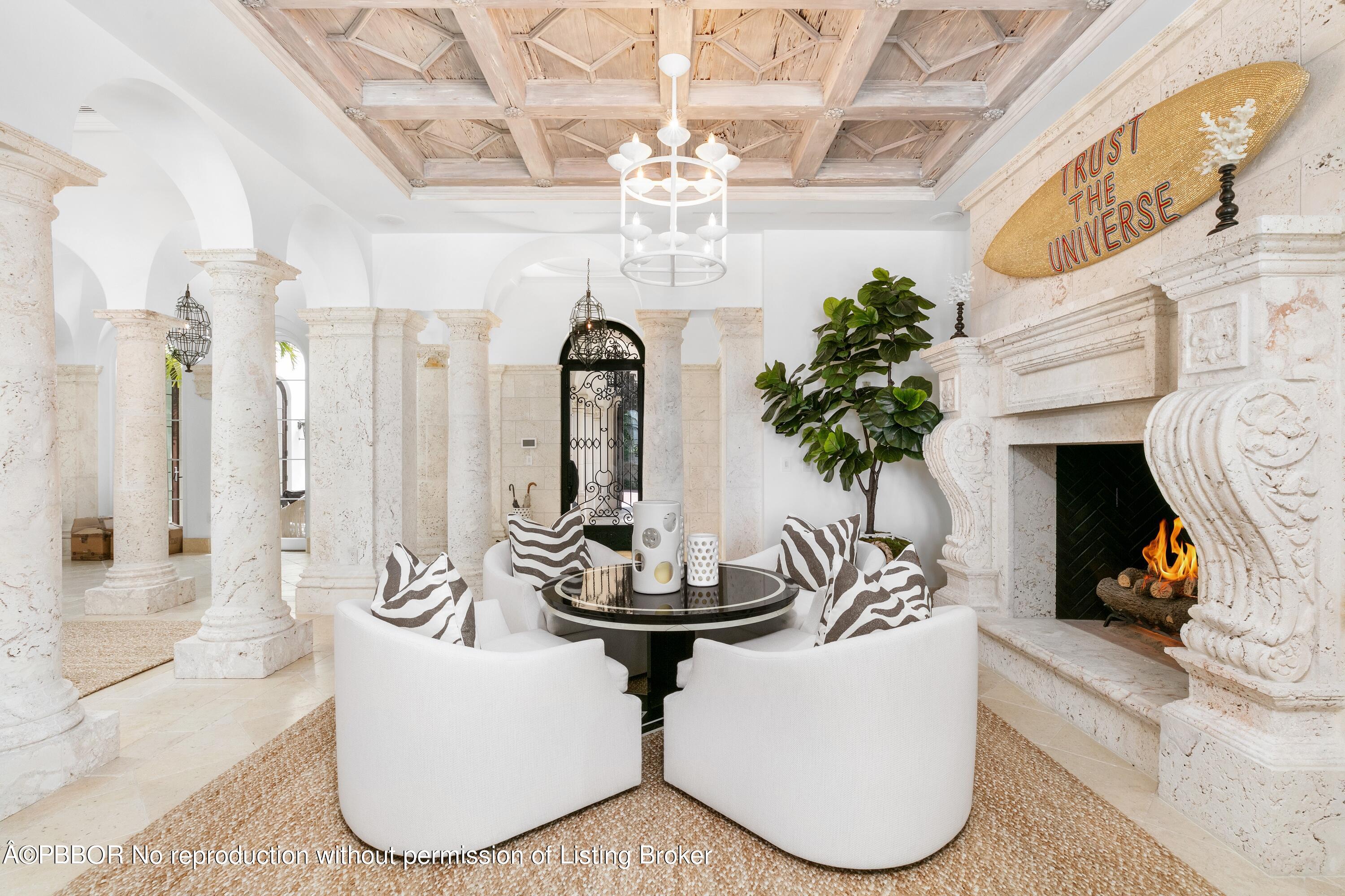 313 Dunbar Road Palm Beach, FL 33480 - Photo 9 of 73 a living room with fireplace furniture and a chandelier