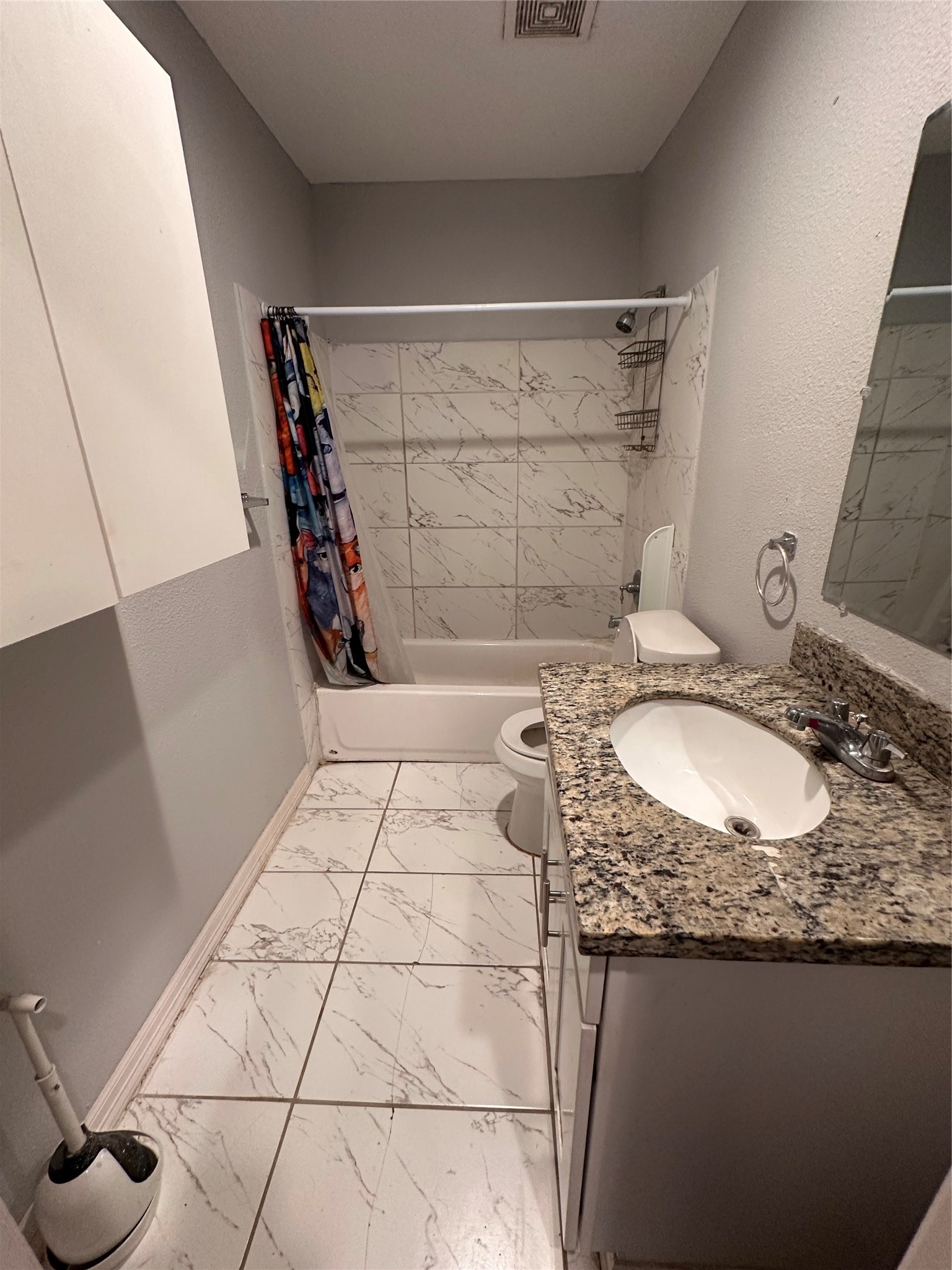 4802 Eppes Street Houston, TX 77021 - Photo 11 of 34 a bathroom with a granite countertop sink a toilet and a mirror