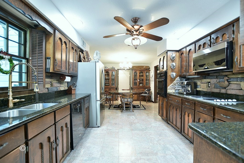 1237 Smith Road Fortson, GA 31808 - Photo 5 of 31 a kitchen with stainless steel appliances granite countertop a sink stove and refrigerator