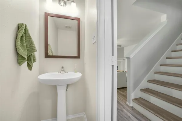 a bathroom with a granite countertop sink a toilet and a mirror