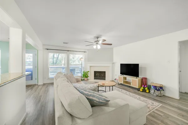 a living room with furniture a rug and a window