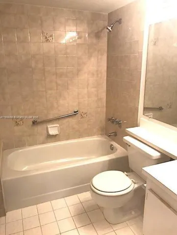 a bathroom with a toilet a sink and bathtub