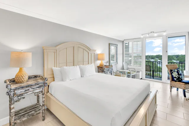 a bedroom with a large bed and a large window